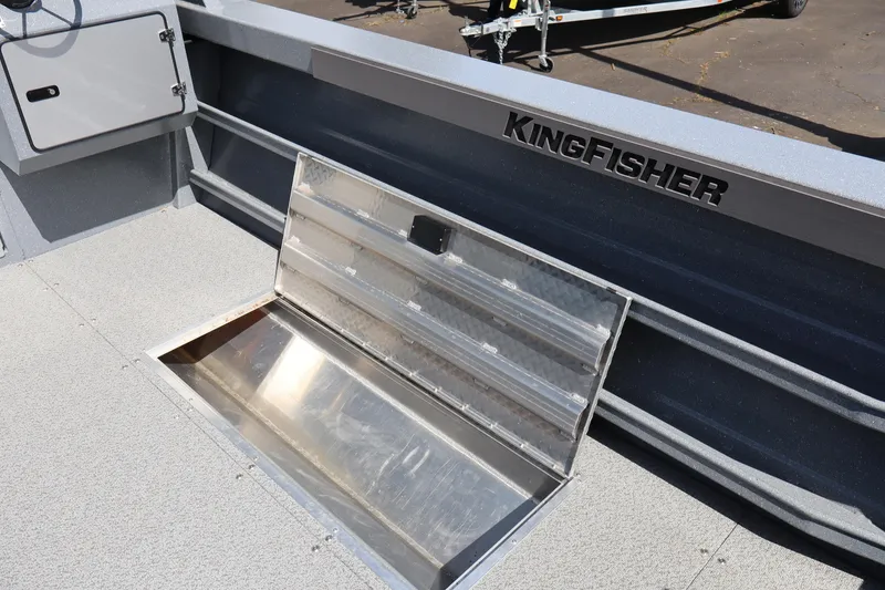 Slide: The Image of 2026 KingFisher 2825 Coastal Express boat interior with open storage compartment. - 17