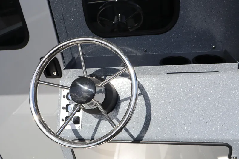 Slide: The Image of Steering wheel of 2026 KingFisher 2825 Coastal Express boat, featuring sleek metallic design. - 19