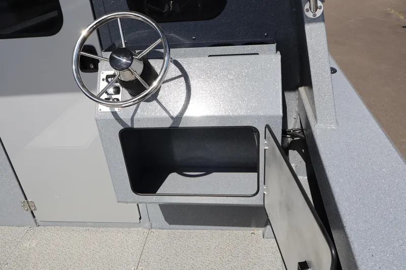 Slide: The Image of Steering console of 2026 KingFisher 2825 Coastal Express boat, featuring storage compartment. - 20