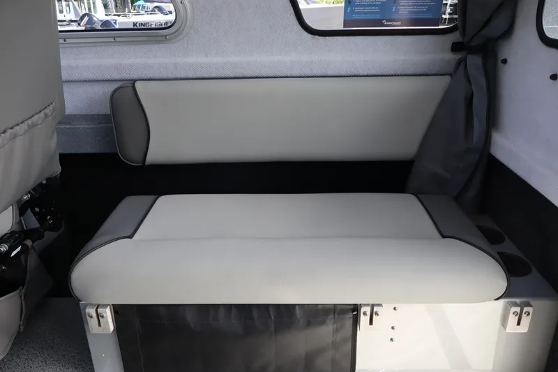 Slide: The Image of Interior seating of 2026 KingFisher 2825 Coastal Express boat, featuring gray upholstery. - 22