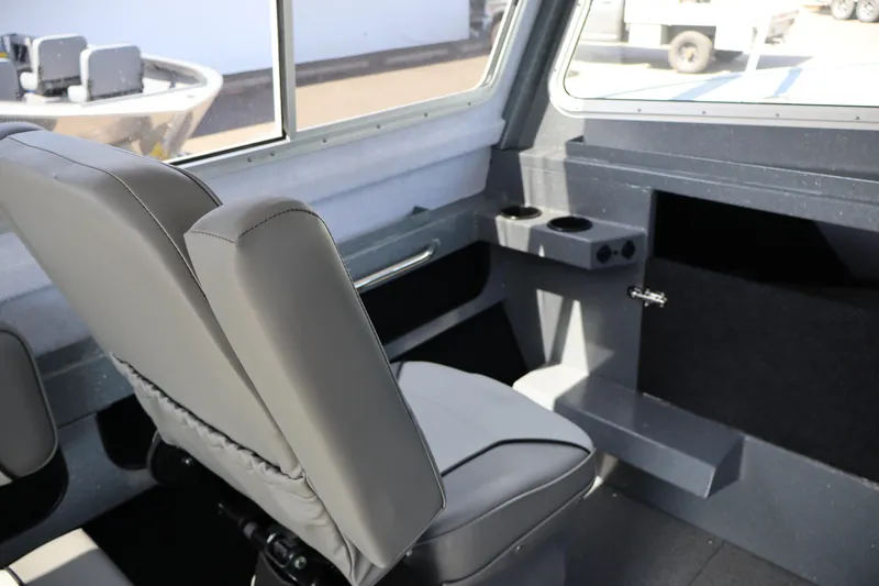 Slide: The Image of Interior of 2026 KingFisher 2825 Coastal Express boat with gray seating and cup holders. - 24