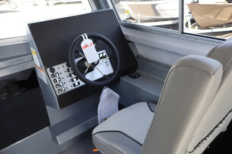 Slide: The Image of Interior of 2026 KingFisher 2825 Coastal Express boat showing steering wheel and controls. - 25