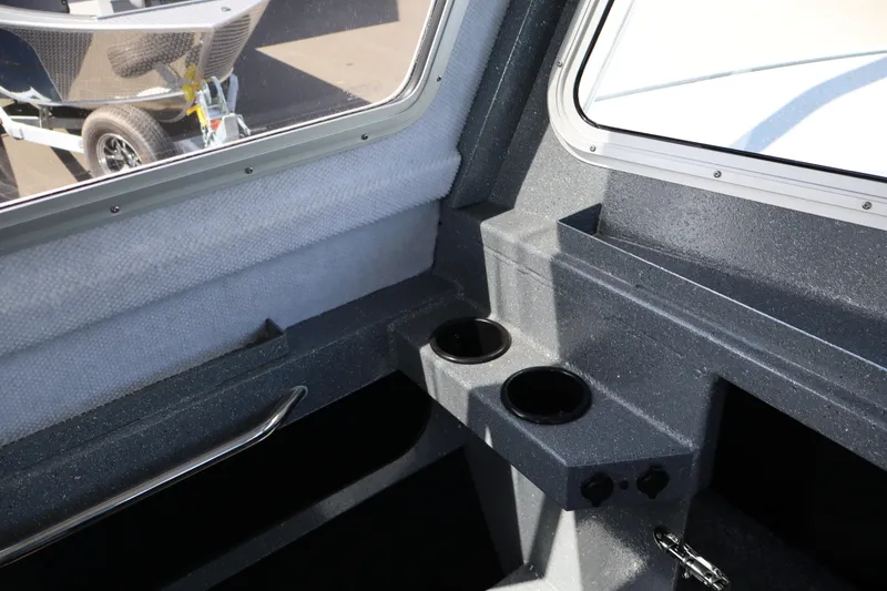 Slide: The Image of Interior view of 2026 KingFisher 2825 Coastal Express boat with cup holders and window. - 28