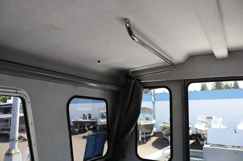 Slide: The Image of Interior view of 2026 KingFisher 2825 Coastal Express boat with windows and curtain rod. - 31