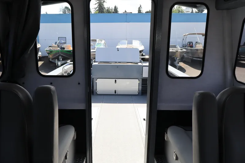 Slide: The Image of Interior view of 2026 KingFisher 2825 Coastal Express boat, showcasing seating and windows. - 32