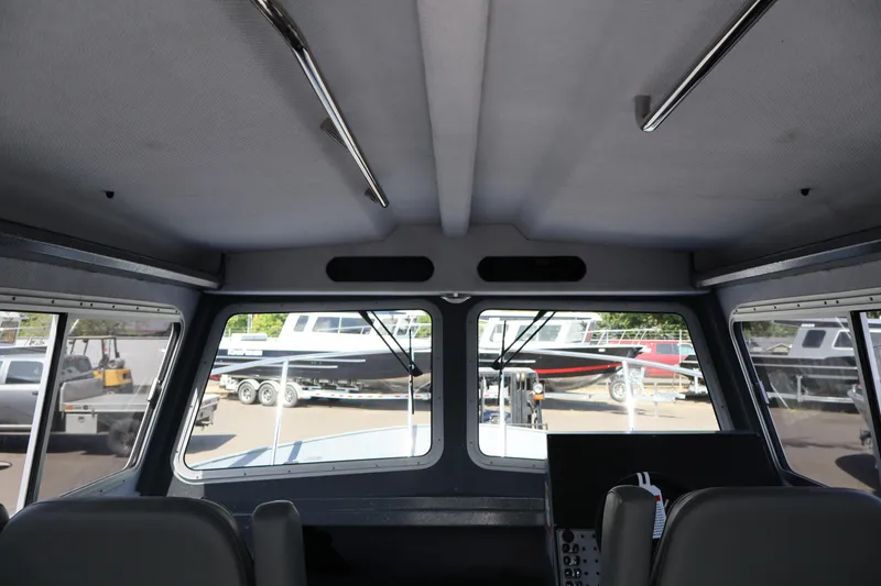 Slide: The Image of Interior view of 2026 KingFisher 2825 Coastal Express boat, showcasing windows and seating. - 33