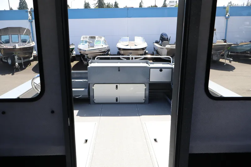 Slide: The Image of Interior view of 2026 KingFisher 2825 Coastal Express boat at a dealership. - 34