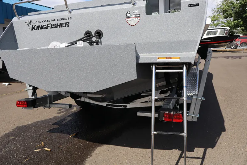 Slide: The Image of 2026 KingFisher 2825 Coastal Express boat rear view with ladder and branding. - 36