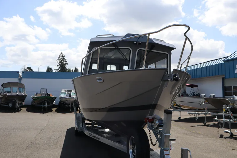 Slide: The Image of 2026 KingFisher 2825 Coastal Express boat on trailer under a cloudy sky. - 4