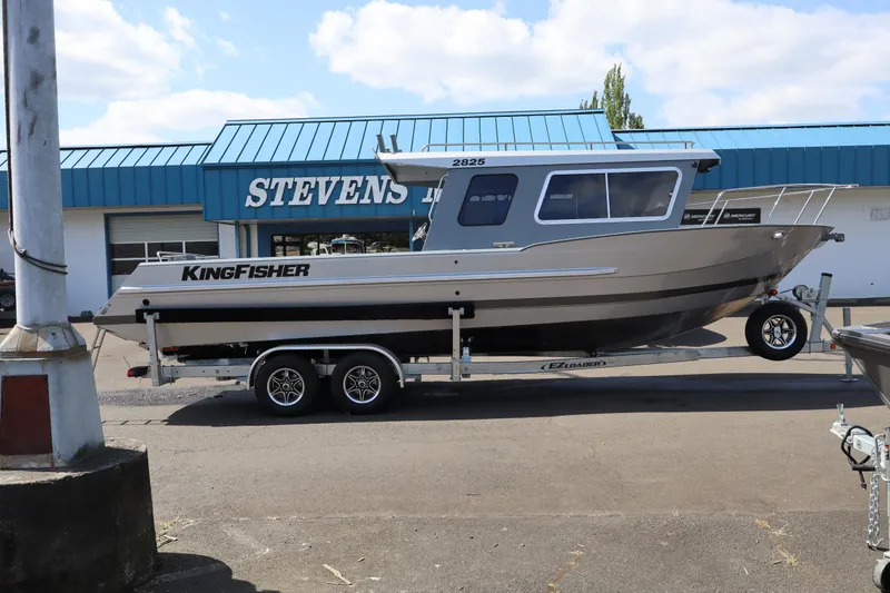 Slide: The Image of 2026 KingFisher 2825 Coastal Express boat on trailer outside Stevens dealership. - 5