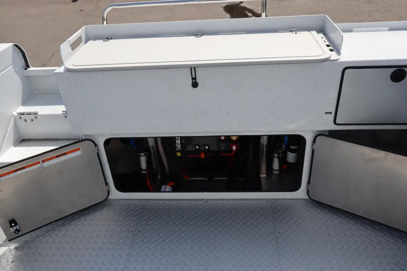 Slide: The Image of 2026 KingFisher 2425 Escape HT boat interior with open storage compartments and visible wiring. - 10
