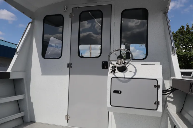 Slide: The Image of Interior view of 2026 KingFisher 2425 Escape HT boat helm with steering wheel. - 18