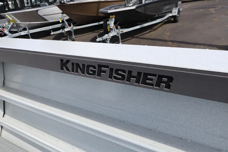 Slide: The Image of 2026 KingFisher 2425 Escape HT boat detail with logo, parked on trailer. - 19