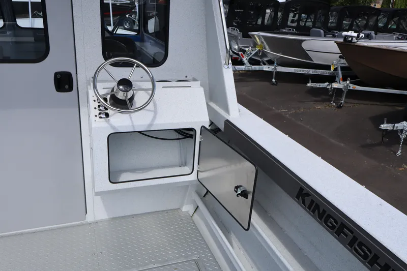 Slide: The Image of Interior view of 2026 KingFisher 2425 Escape HT boat with steering wheel and storage compartment. - 21