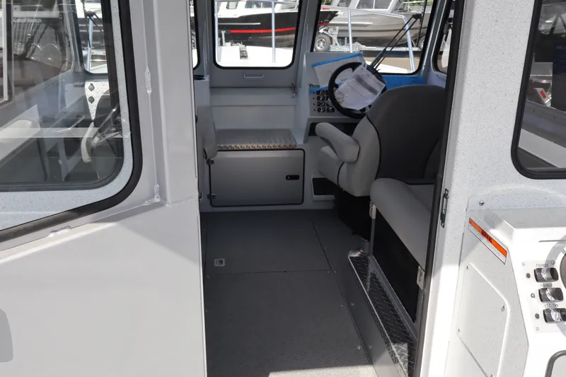 Slide: The Image of Interior view of 2026 KingFisher 2425 Escape HT boat, featuring seating and control panel. - 22