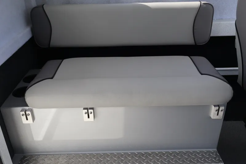Slide: The Image of Interior seating of 2026 KingFisher 2425 Escape HT boat, featuring cushioned bench and storage. - 24