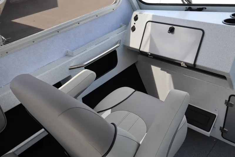 Slide: The Image of Interior of 2026 KingFisher 2425 Escape HT boat, featuring modern seating and dashboard. - 25
