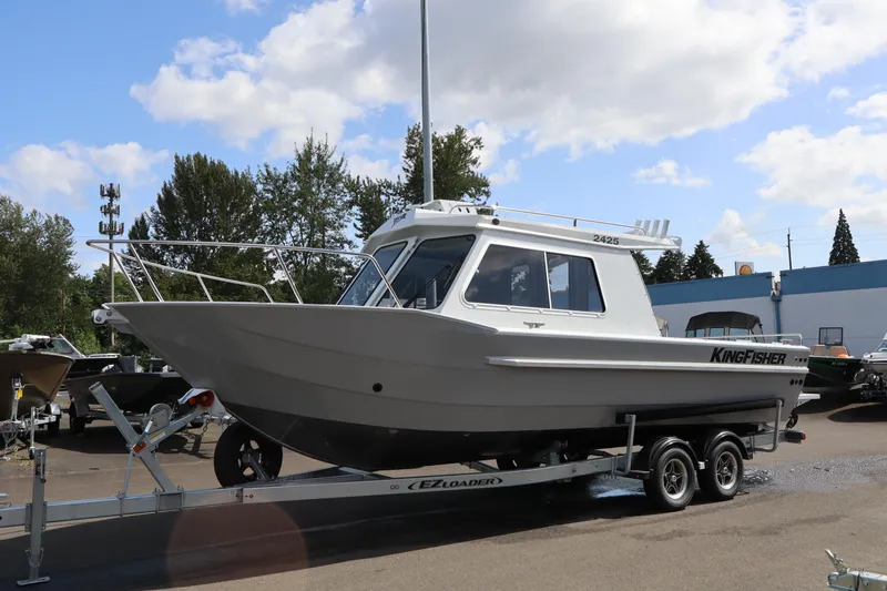 Slide: The Image of Interior of 2026 KingFisher 2425 Escape HT boat, featuring steering wheel and captain's chair. - 26