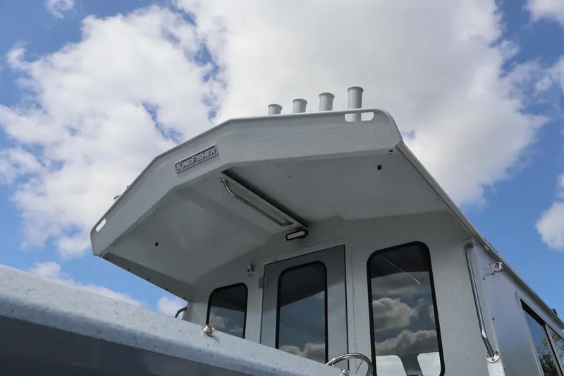 Slide: The Image of 2026 KingFisher 2425 Escape HT boat against a cloudy sky backdrop. - 4