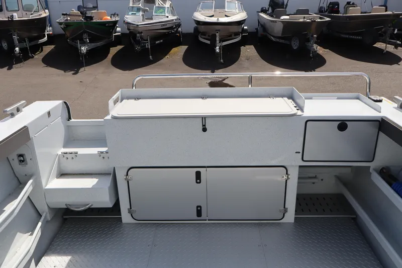 Slide: The Image of 2026 KingFisher 2425 Escape HT boat interior with storage compartments and seating. - 7