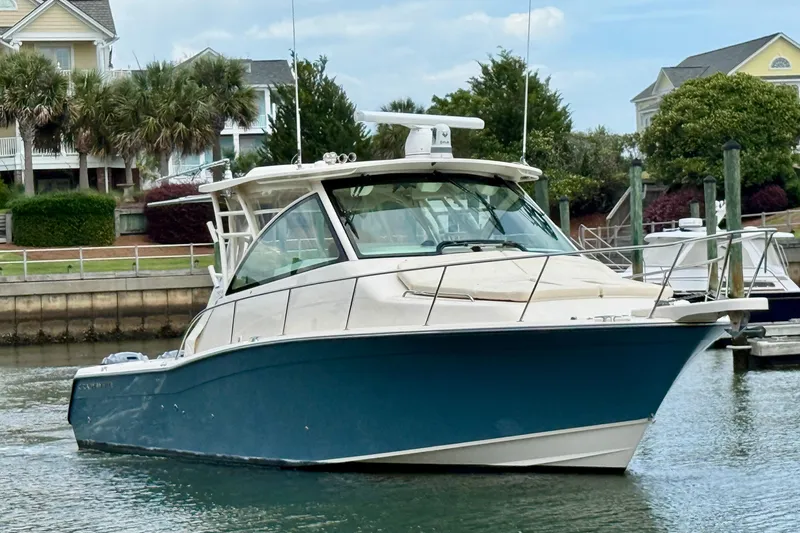 The Image of 2021 Grady-White Express 370 boat docked in a scenic marina setting. - 0