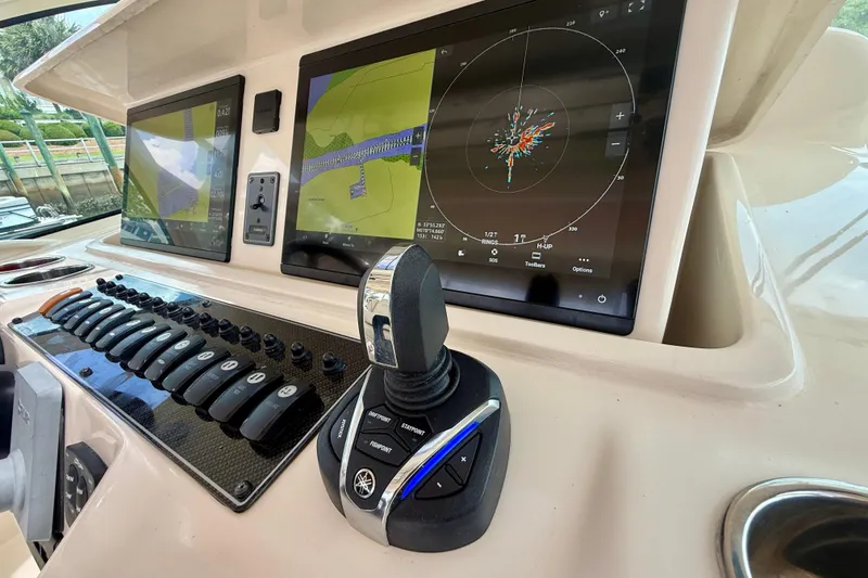 Slide: The Image of Control panel of 2021 Grady-White Express 370 boat with navigation screens and joystick. - 10