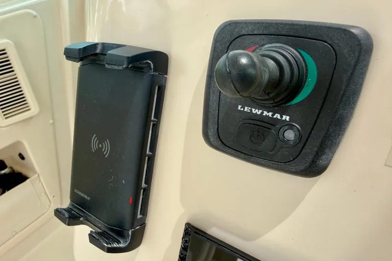Slide: The Image of Control panel and phone holder on 2021 Grady-White Express 370 boat. - 11