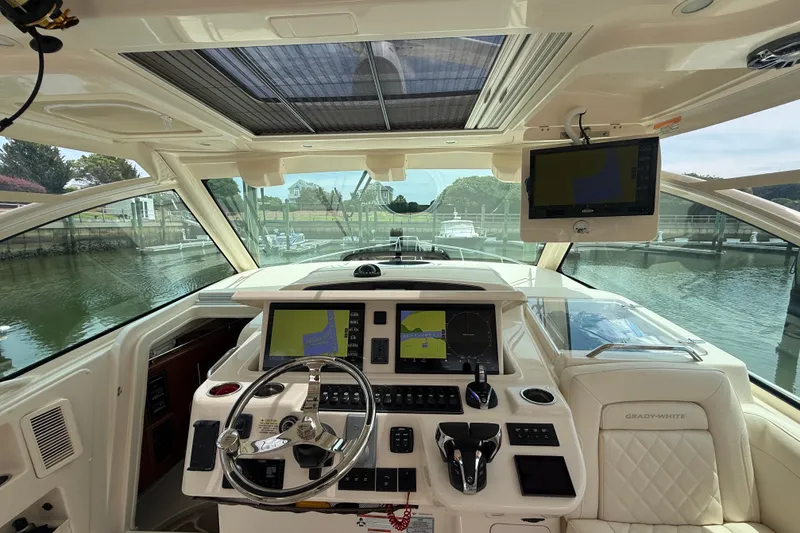Slide: The Image of Helm of 2021 Grady-White Express 370 boat with advanced navigation systems. - 12