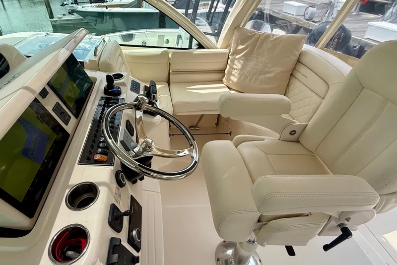 Slide: The Image of Luxurious helm of 2021 Grady-White Express 370 with plush seating and advanced controls. - 14