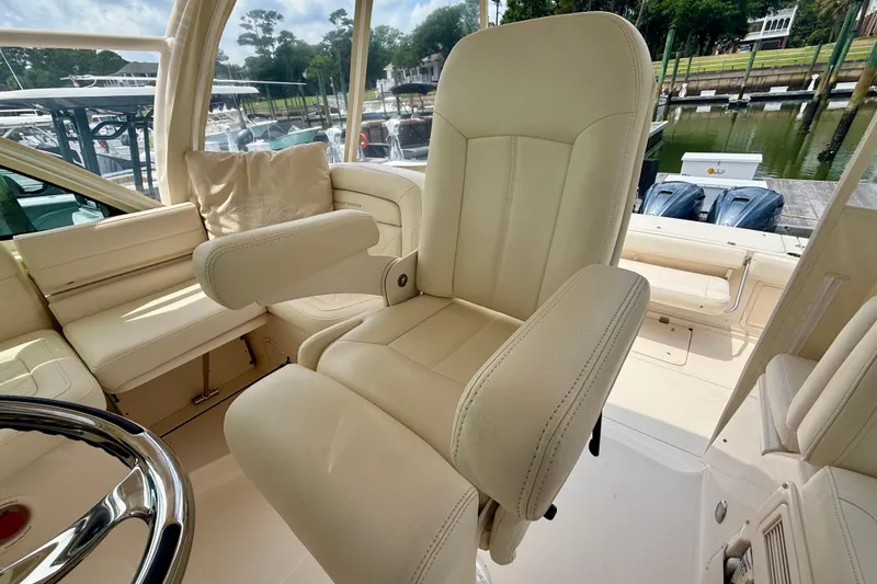 Slide: The Image of Luxury seating on a 2021 Grady-White Express 370 boat, docked at a marina. - 15