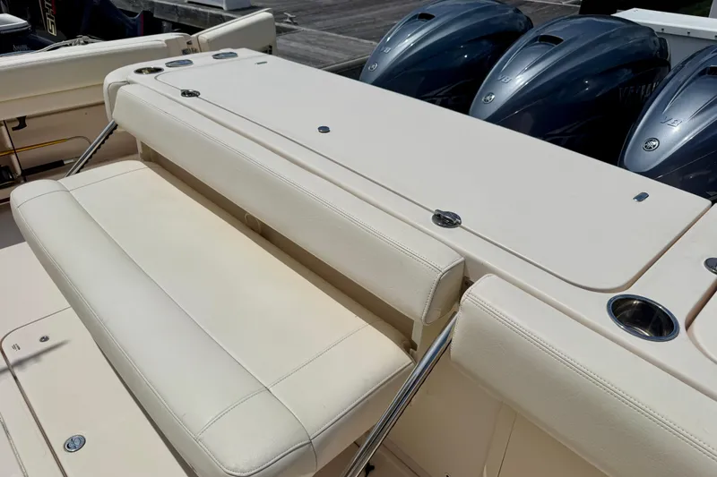 Slide: The Image of 2021 Grady-White Express 370 boat with cushioned seating and multiple outboard engines. - 19