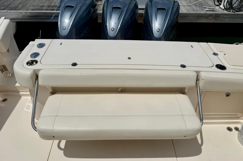 Slide: The Image of 2021 Grady-White Express 370 boat with triple outboard engines and foldable seating. - 20