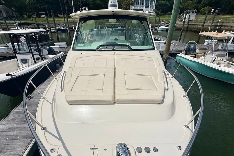 Slide: The Image of 2021 Grady-White Express 370 boat docked at marina, featuring spacious deck and sleek design. - 23