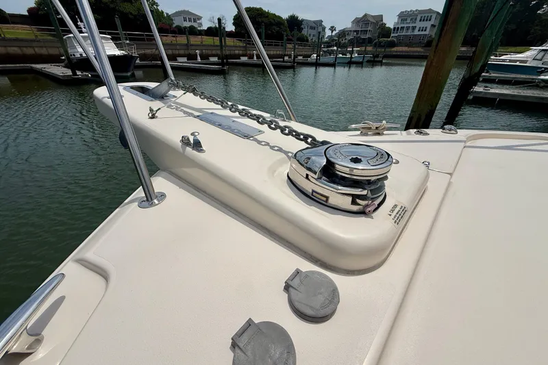 Slide: The Image of Bow of 2021 Grady-White Express 370 boat with anchor chain and winch in marina. - 24