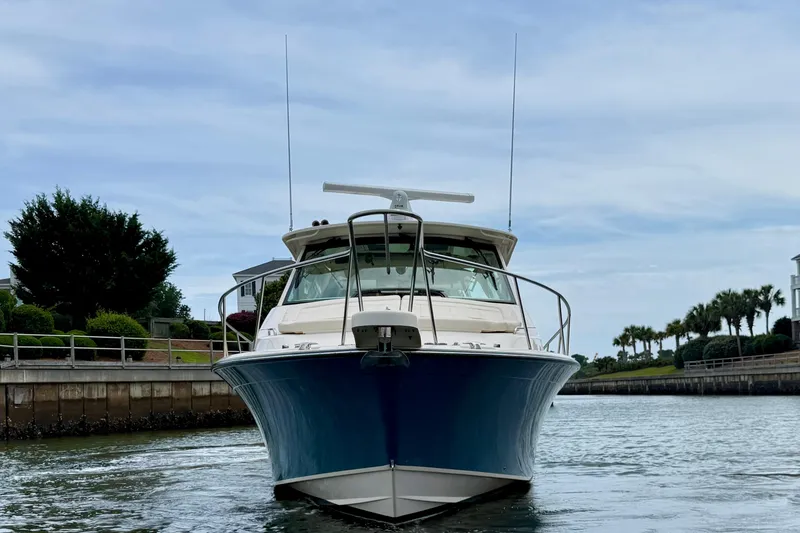 Slide: The Image of 2021 Grady-White Express 370 boat docked in a scenic marina setting. - 3