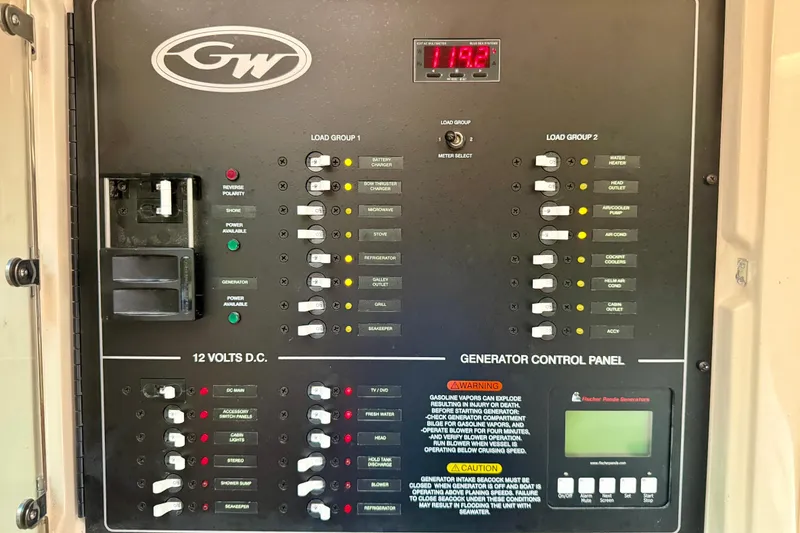 Slide: The Image of 2021 Grady-White Express 370 generator control panel with various switches and indicators. - 35