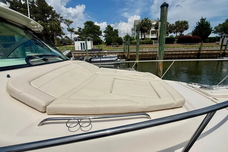 Slide: The Image of 2021 Grady-White Express 370 boat with cushioned deck, docked near waterfront homes. - 38