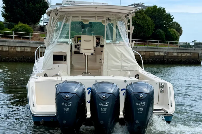 Slide: The Image of 2021 Grady-White Express 370 boat with triple Yamaha 425 V8 engines on water. - 6
