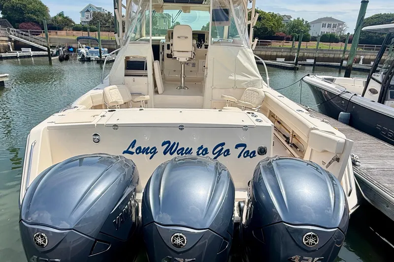 Slide: The Image of 2021 Grady-White Express 370 boat with triple Yamaha engines docked at marina. - 7