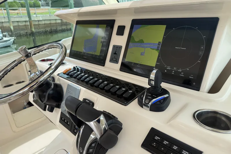 Slide: The Image of 2021 Grady-White Express 370 helm with advanced navigation displays and controls. - 9