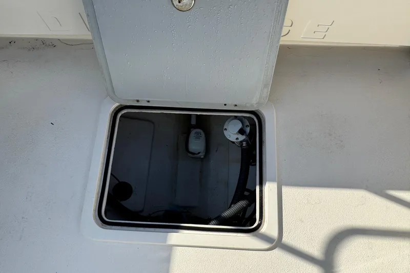 Slide: The Image of Open hatch on 2023 Defiance Admiral 220 EX boat deck, revealing interior compartment. - 10