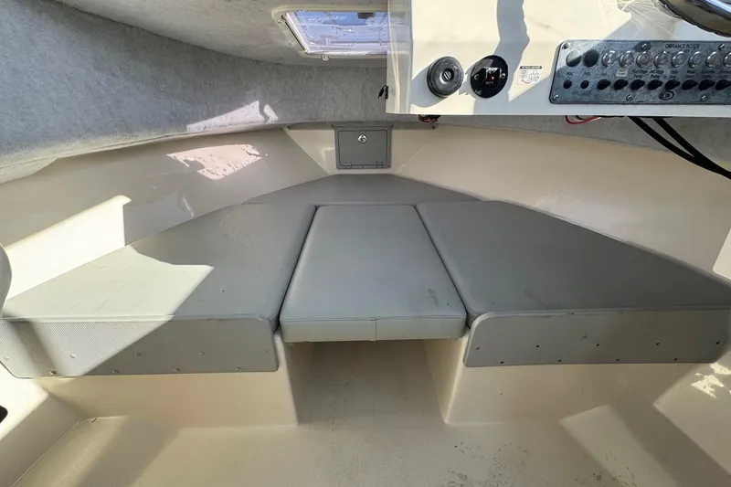 Slide: The Image of 2023 Defiance Admiral 220 EX cabin interior with cushioned seating and control panel. - 18