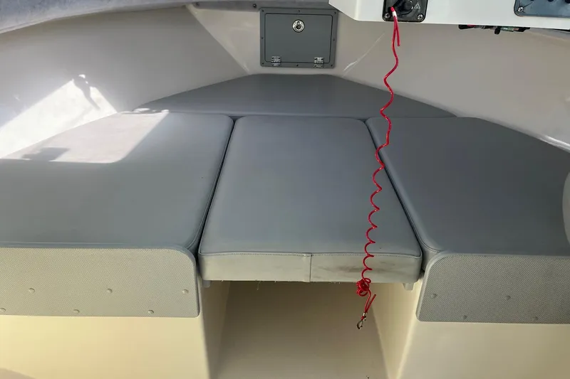 Slide: The Image of Interior view of 2023 Defiance Admiral 220 EX boat with cushioned seating. - 19