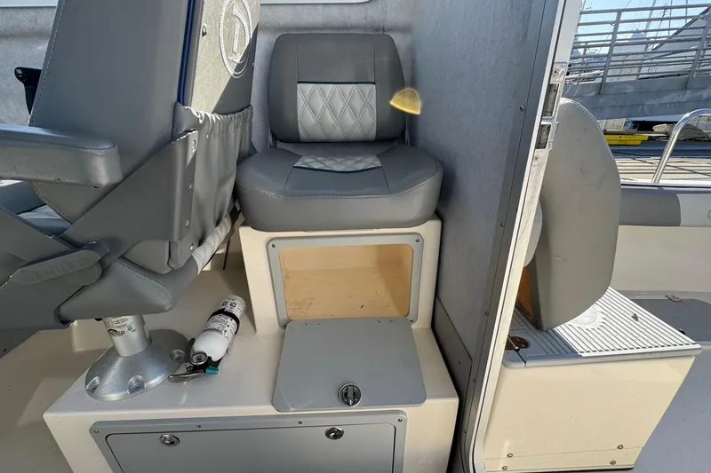 Slide: The Image of 2023 Defiance Admiral 220 EX boat interior with seating and storage compartments. - 21
