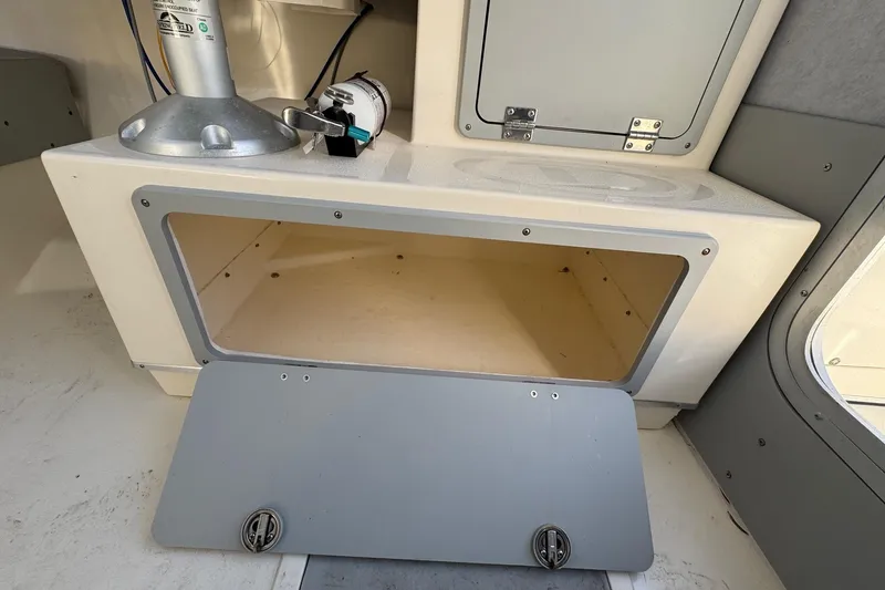 Slide: The Image of 2023 Defiance Admiral 220 EX boat interior storage compartment with open hatch. - 22
