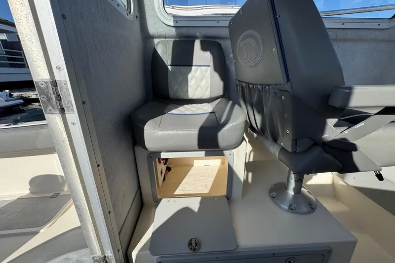 Slide: The Image of 2023 Defiance Admiral 220 EX boat interior seating with storage compartment. - 24