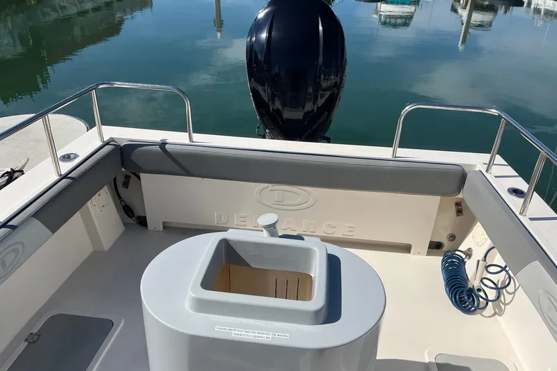 Slide: The Image of 2023 Defiance Admiral 220 EX boat interior with motor and seating area. - 28