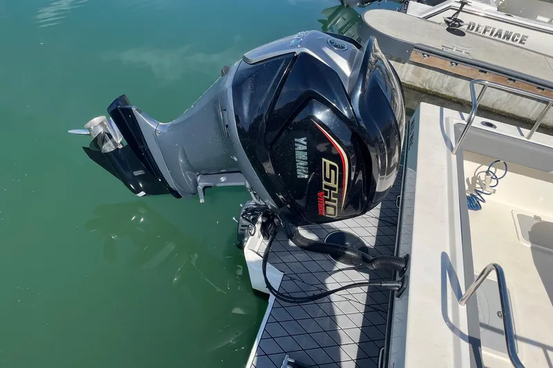 Slide: The Image of 2023 Defiance Admiral 220 EX with Yamaha outboard motor on calm water. - 29