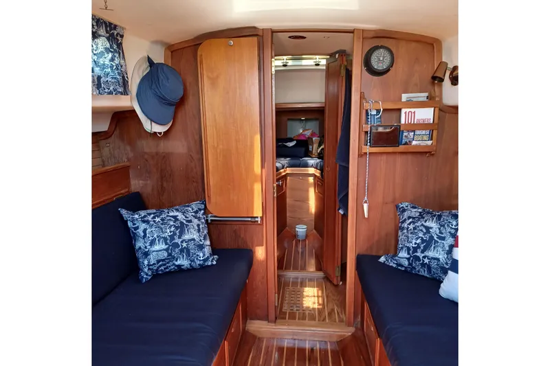 Slide: The Image of Interior of a 1982 Cape Dory boat with wooden paneling and nautical decor. - 4