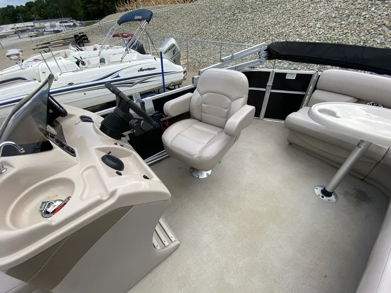 Slide: The Image of Interior of a 2015 Starcraft Freedom 180 Tiller boat with steering console. - 12